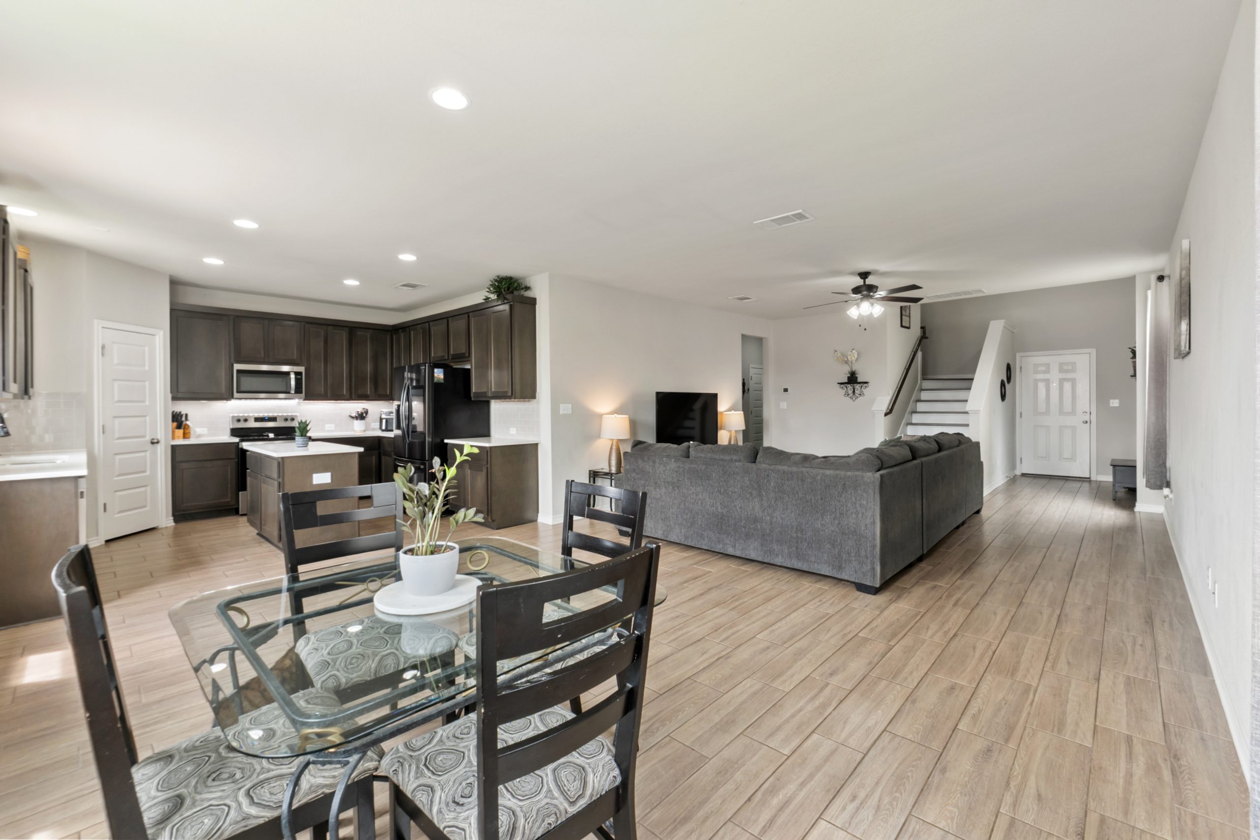 virtual staging vs virtual remodeling example; furnished living/dining/kitchen space before virtual staging
