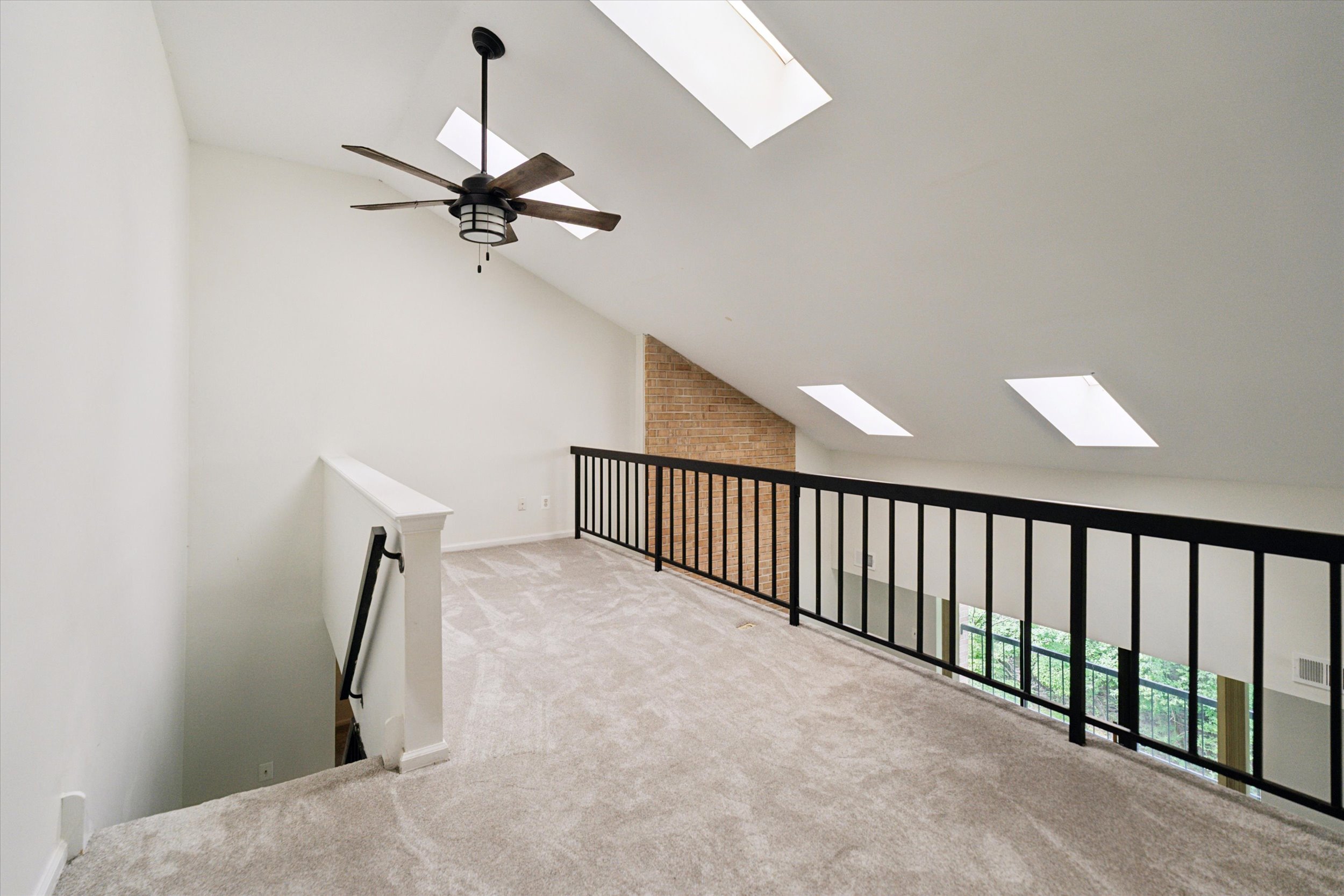 vacant loft space with black iron railing