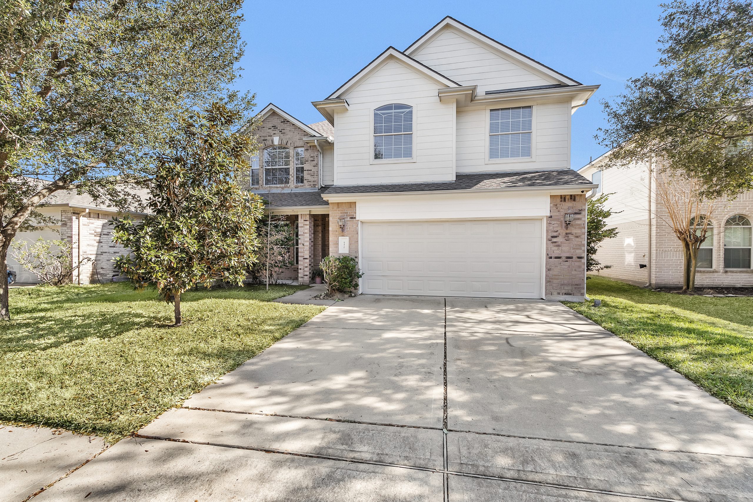 Front yard of a residential home with minimal landscaping