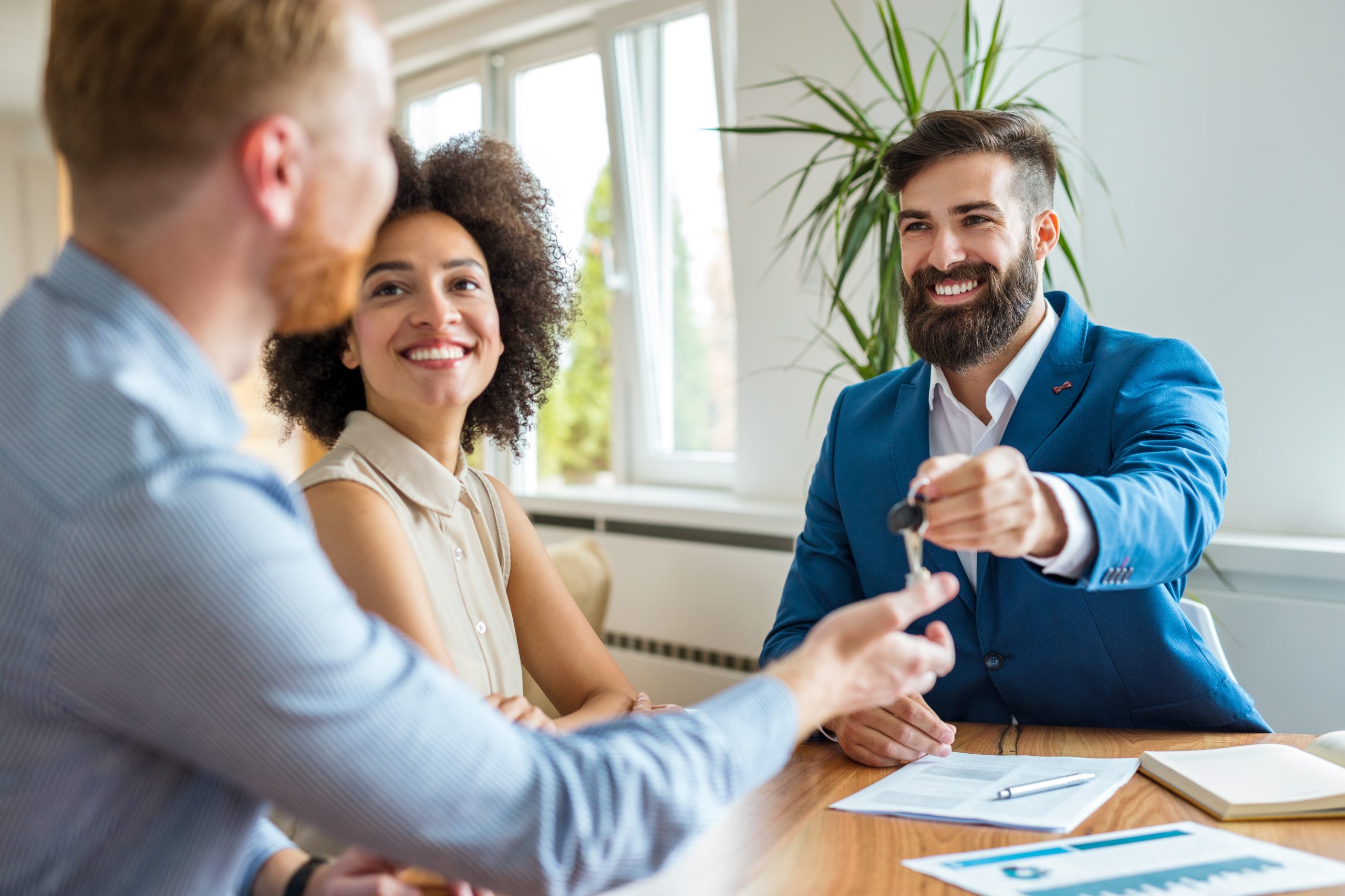 Real Estate agent giving keys to new homeowners