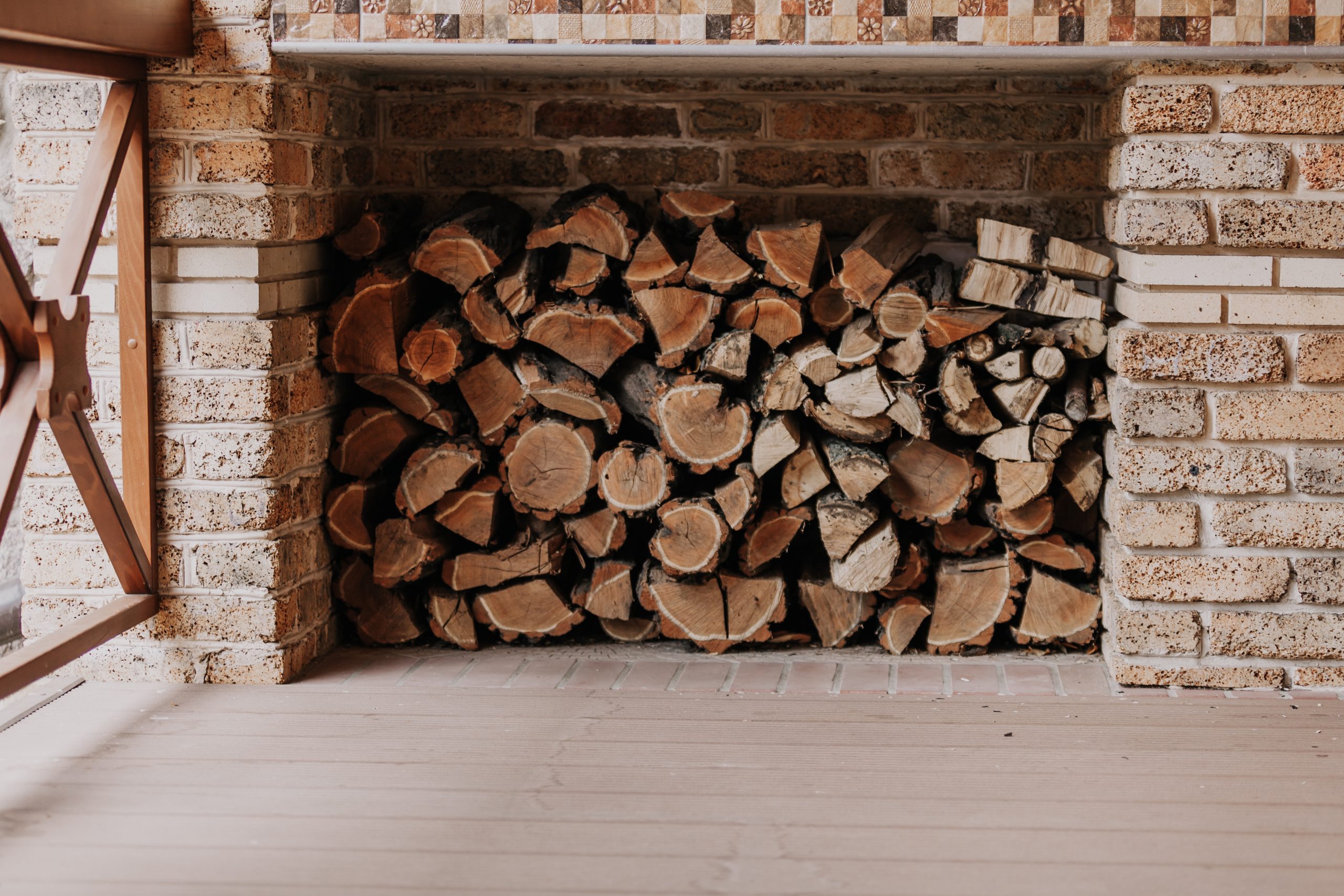 Firewood stacked in niche on veranda for winter home décor ideas