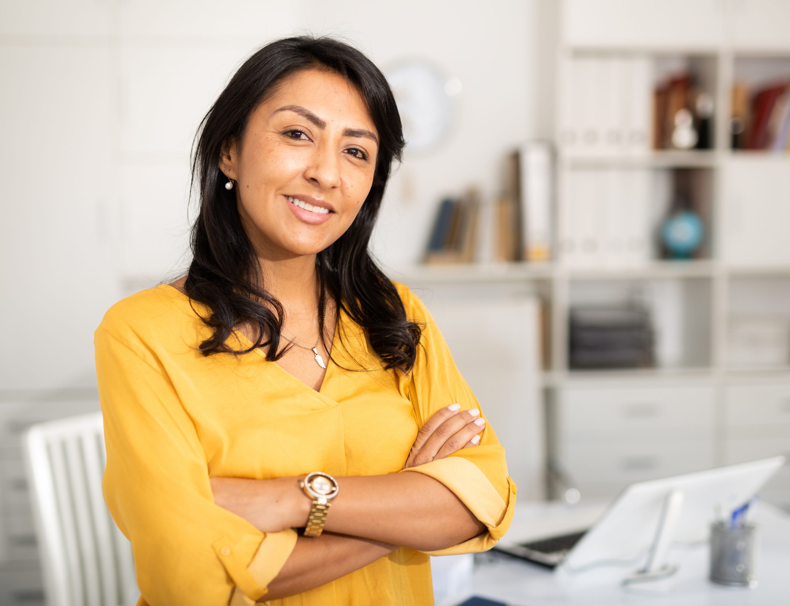 Happy smiling businesswoman standing in office