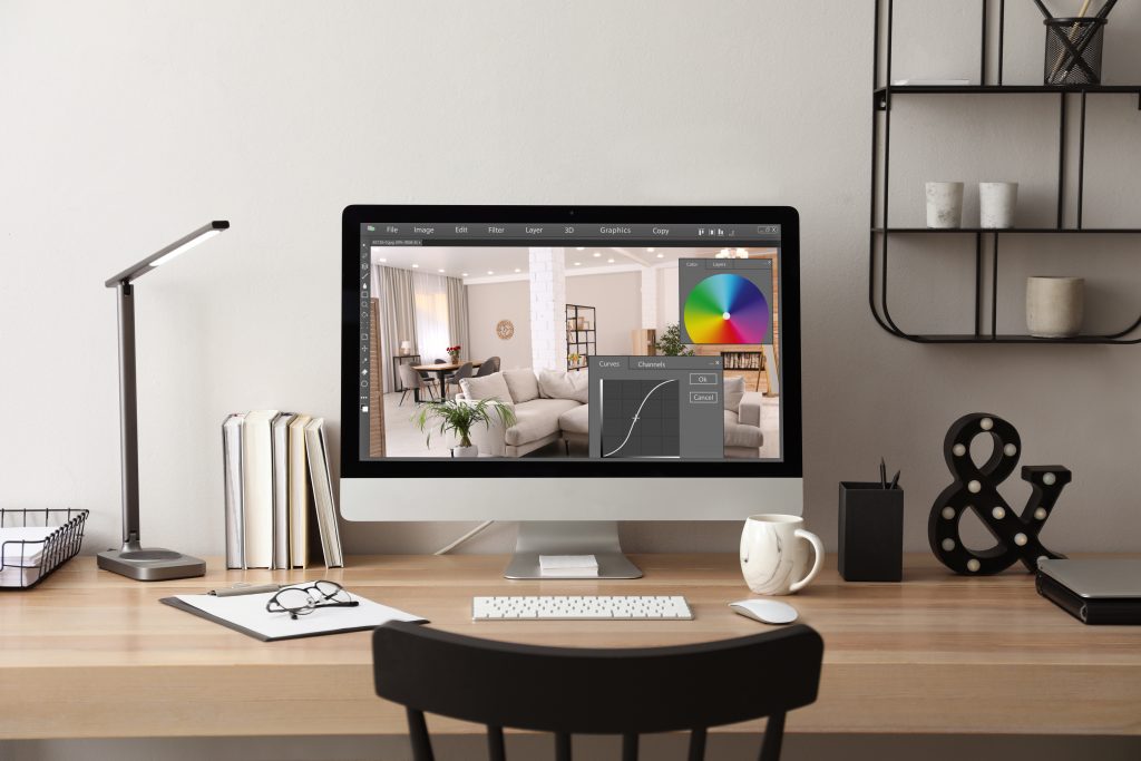 desktop space of a real estate photography business' photo editor color correcting an image