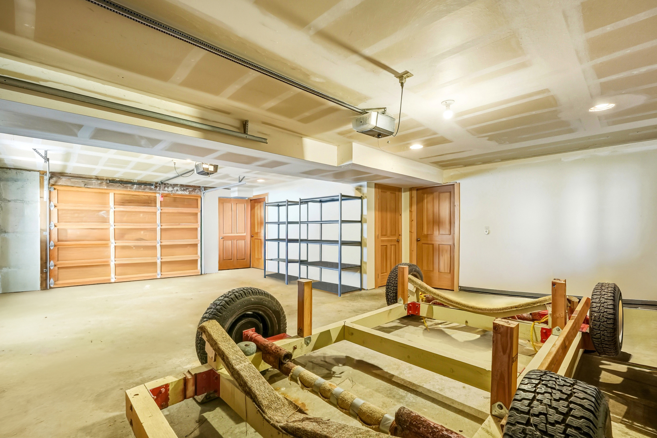 Garage, after virtual decluttering, mostly empty with shelving