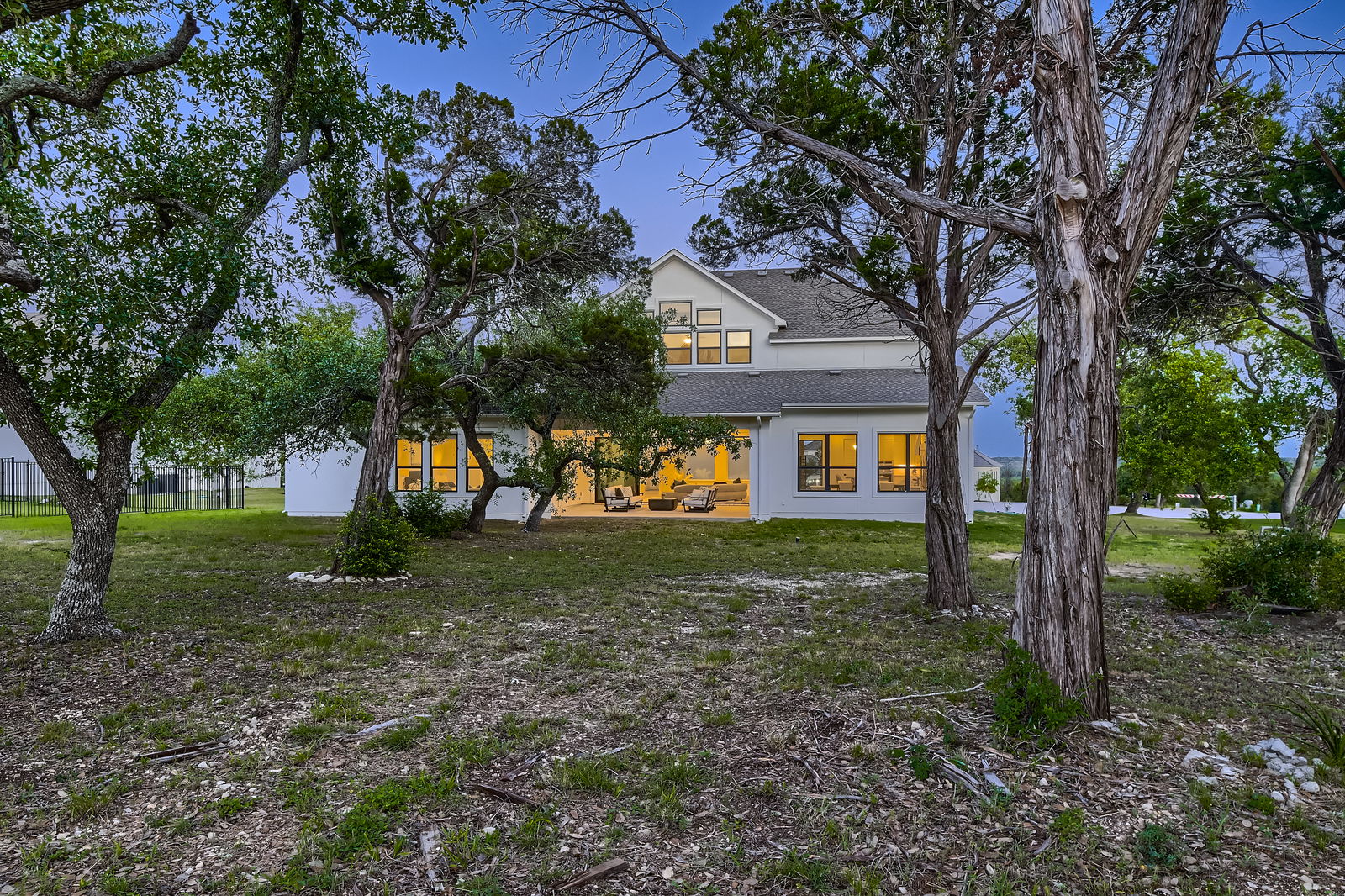 Virtual staging vs virtual remodeling; rural residential house, backyard with trees