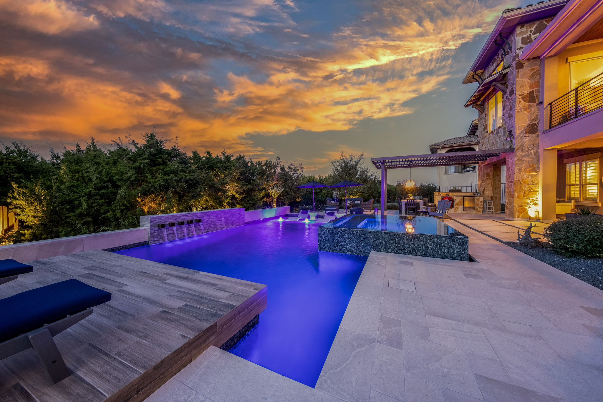 2023 pool trends - image of a residential pool lit up at night by LED lights, image taken by Square Foot Photography