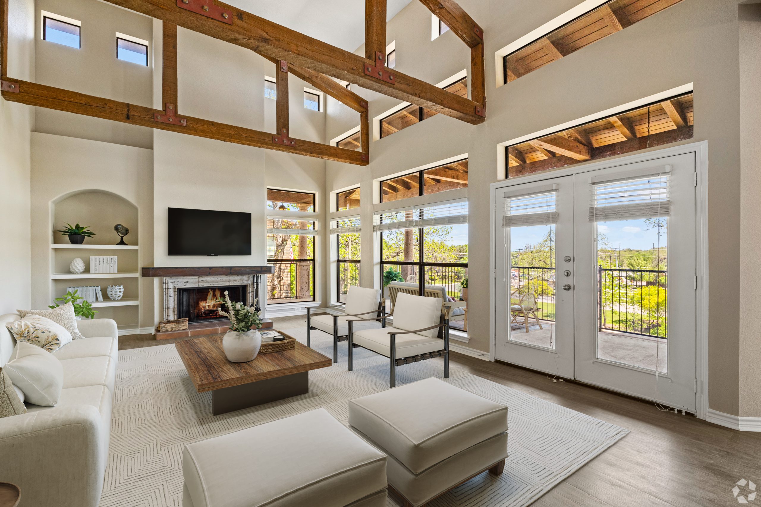 Virtually staged apartment living room with lofted ceiling and wraparound balcony