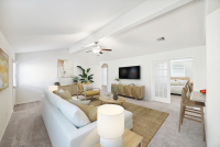 after virtual staging; beautiful living room with sectional, area rug, etc