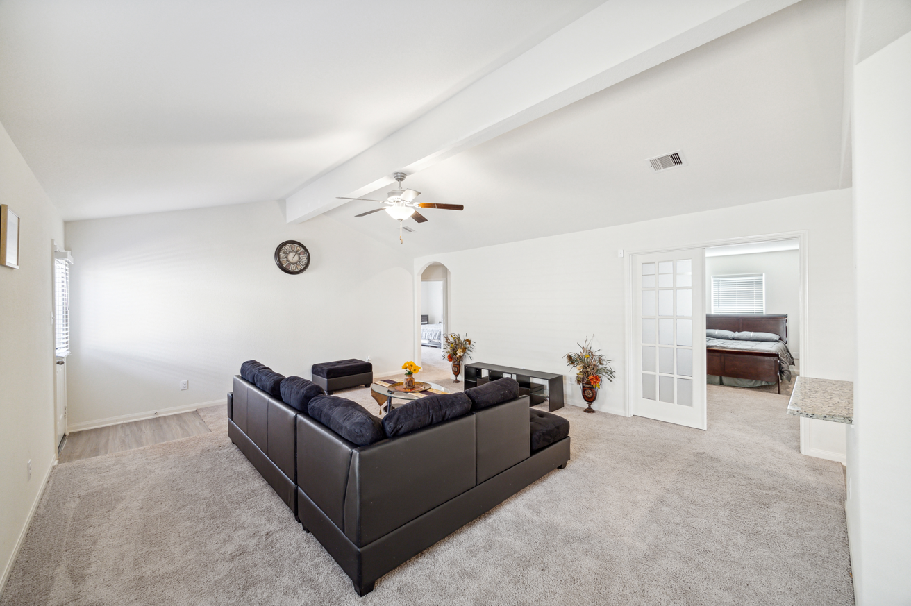 before decluttering and staging; living room with black sectional couch